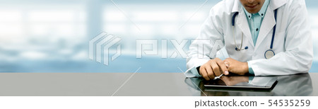 Doctor with tablet computer at hospital office. Doctor with tablet computer at hospital office. 54535259