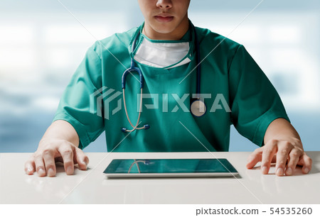 Surgeon doctor with tablet computer at hospital. Surgeon doctor with tablet computer at hospital. 54535260