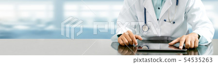 Doctor with tablet computer at hospital office. Doctor with tablet computer at hospital office. 54535263