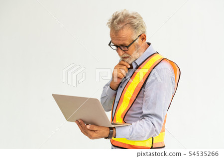 Senior foreman or engineer using laptop computer. Senior foreman or engineer using laptop computer. 54535266