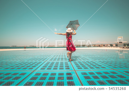 Happy woman traveler dances on outdoor floor. Happy woman traveler dances on outdoor floor. 54535268