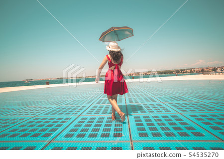 Happy woman traveler dances on outdoor floor. Happy woman traveler dances on outdoor floor. 54535270