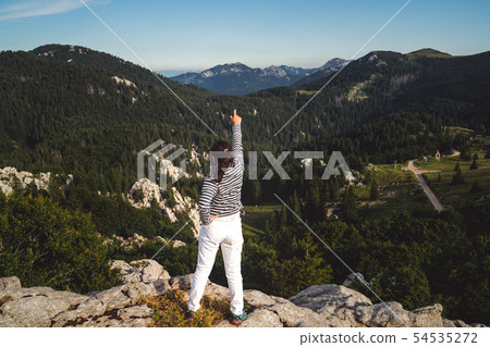 Woman traveler hiking across Croatia landscape. Woman traveler hiking across Croatia landscape. 54535272