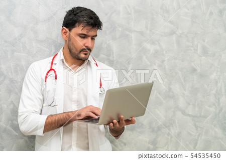 Doctor using laptop computer at the hospital. 54535450