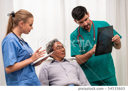 Doctor team work with x ray film image of patient. 54535603