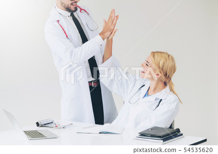 Happy doctor celebrates success with partner. Happy doctor celebrates success with partner. 54535620