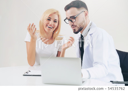 Male Doctor and Female Patient in Hospital Office Male Doctor and Female Patient in Hospital Office 54535762