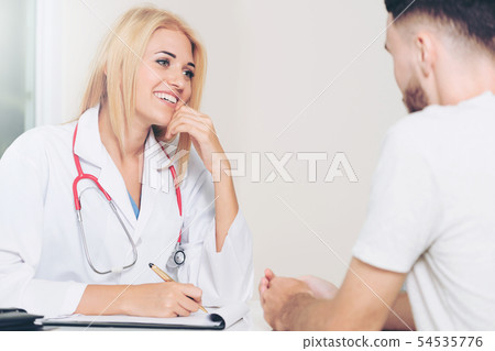 Woman Doctor and Male Patient in Hospital Office Woman Doctor and Male Patient in Hospital Office 54535776
