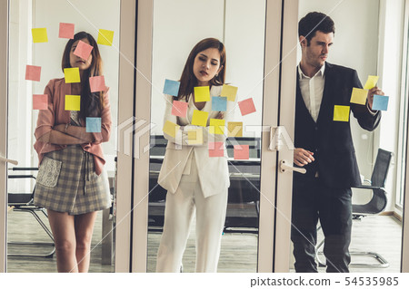 Unhappy business people standing in office. 54535985