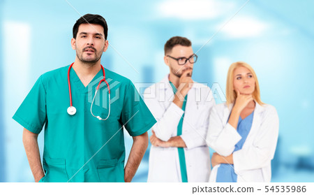 Doctor working in hospital with other doctors. 54535986