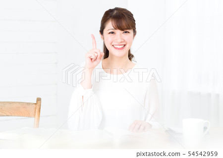 A young woman pointing at number 1 54542959