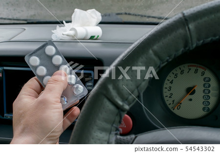 driver holds a package of pills driver holds a package of pills 54543302