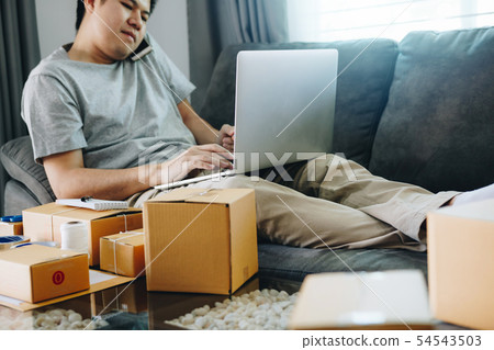 Entrepreneur is talking on the phone and using a Entrepreneur is talking on the phone and using a 54543503