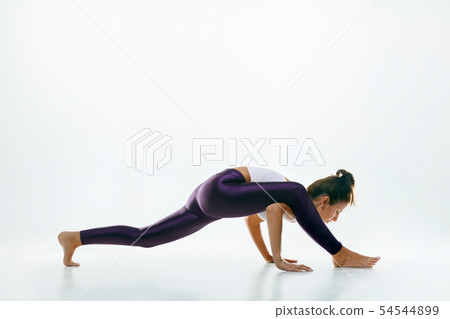 Sporty young woman doing yoga practice isolated on white background 54544899