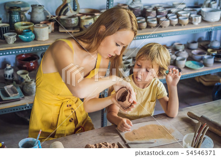 mother and son doing ceramic pot in pottery workshop 54546371