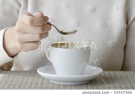 Closeup photo of a woman drinking coffee from a 54547569
