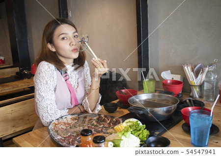 young asian woman enjoy eating Shabu-Shabu 54547941