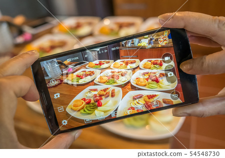 taking photo at breakfast 54548730