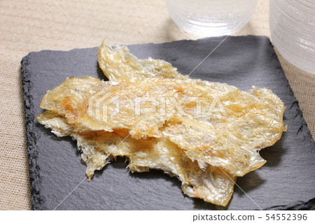A snack and grilled on a slate plate. A snack image of sake. 54552396