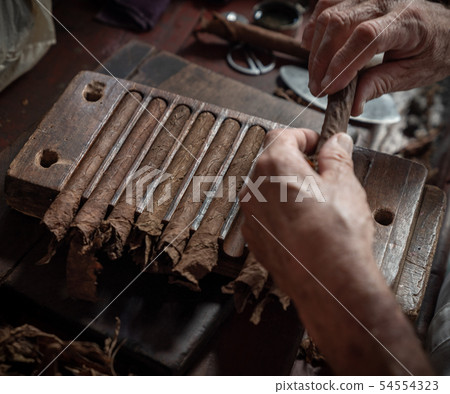 Cigar rolling or making by torcedor in cuba 54554323