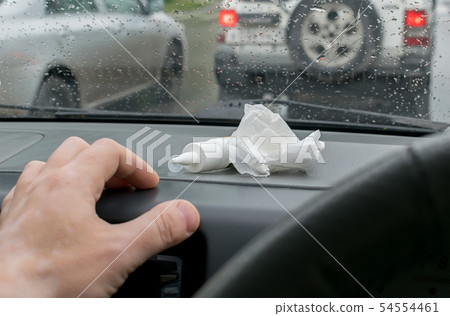 Driver holds a spray from a runny nose 54554461