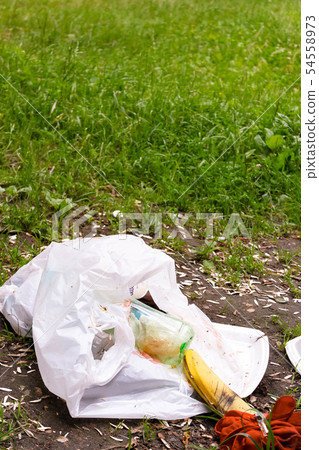 Plastic bag with trash and disposable utensils on 54558973
