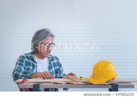 Old Construction Builder with tools and paper plan Old Construction Builder with tools and paper plan 54560229