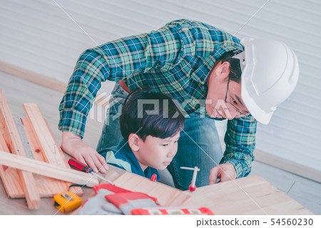 Little Boy is learning to work on wood and be a Little Boy is learning to work on wood and be a 54560230