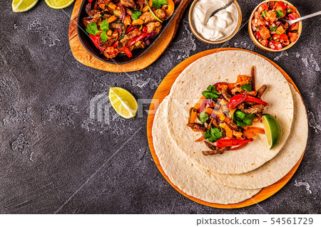 FAJITAS with colored pepper and onions, served FAJITAS with colored pepper and onions, served 54561729
