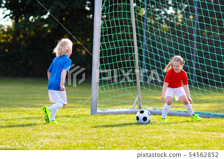Kids play football. Child at soccer field. Kids play football. Child at soccer field. 54562852