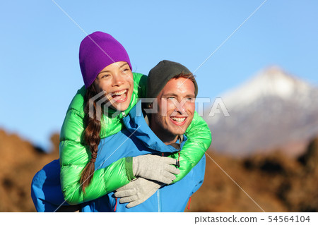Couple piggyback happy in active lifestyle 54564104