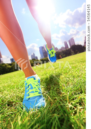 Runner - running shoes on woman athlete 54564145