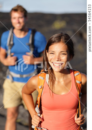 Hiking couple - Asian woman hiker walking on lava Hiking couple - Asian woman hiker walking on lava 54564153