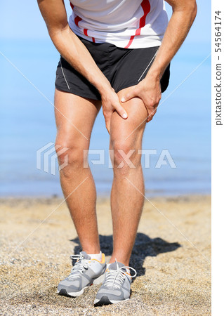 Muscle injury. Man runner sprain thigh muscles 54564174