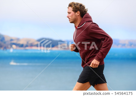 Runner athlete man running in sweatshirt 54564175