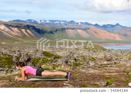 Exercising fitness woman doing plank in nature 54564184