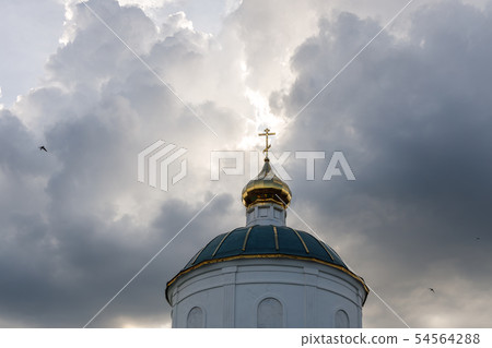 Golden dome with a cross of a small old church 54564288