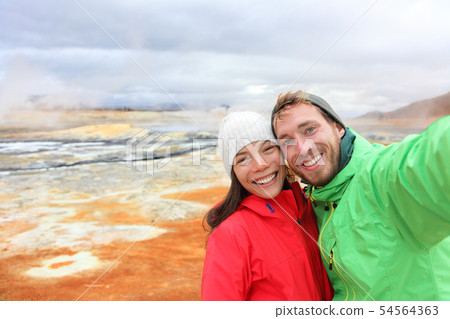Iceland tourists selfie at mudpot hot spring Iceland tourists selfie at mudpot hot spring 54564363
