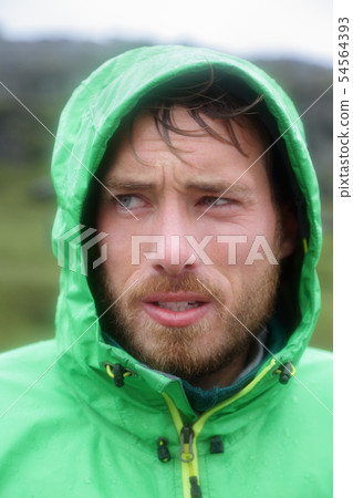 Raincoat - man outdoors in rain jacket 54564393