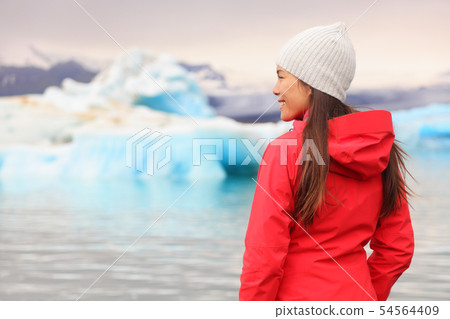 Woman at glacier lagoon on Iceland Woman at glacier lagoon on Iceland 54564409