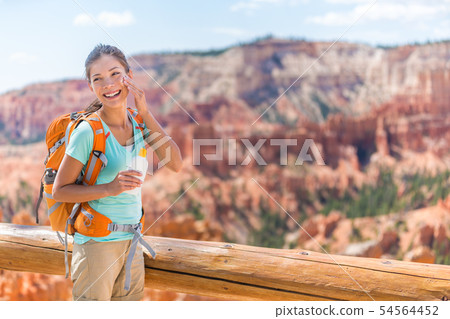 Hiker sunscreen - Woman hiking putting sunblock 54564452