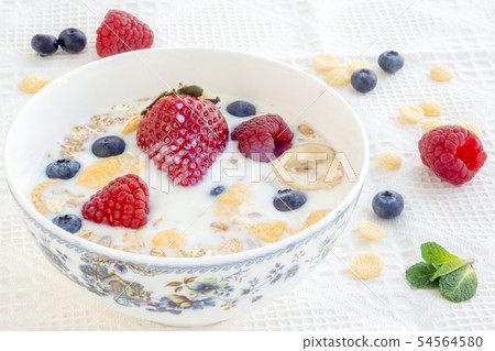 Milk with muesli and berries for breakfast 54564580