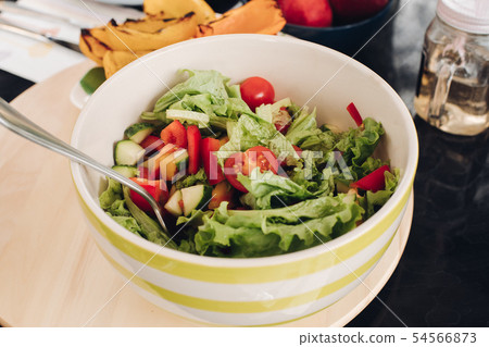 Delicious fresh salad in a bowl.Close-up of tasty Delicious fresh salad in a bowl.Close-up of tasty 54566873