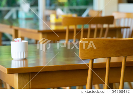 Wooden table and chair in the coffee shop cafe. Wooden table and chair in the coffee shop cafe. 54568482