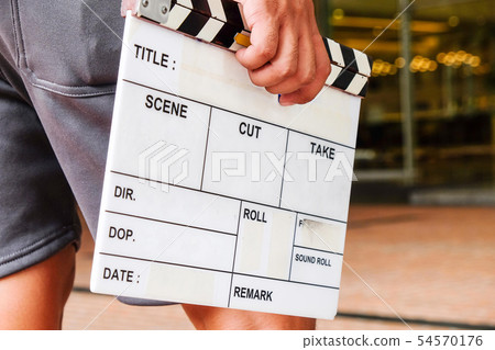 Man hands holding movie clapper. 54570176
