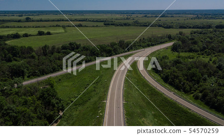 Aerial view of 3 highway road connected in 1 interchange seen from above. Aerial view of 3 highway road connected in 1 interchange seen from above. 54570259
