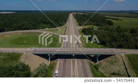Aerial view of highway cloverleaf interchange seen from above. 54570441