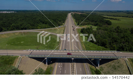 Aerial view of highway cloverleaf interchange seen from above. Aerial view of highway cloverleaf interchange seen from above. 54570442