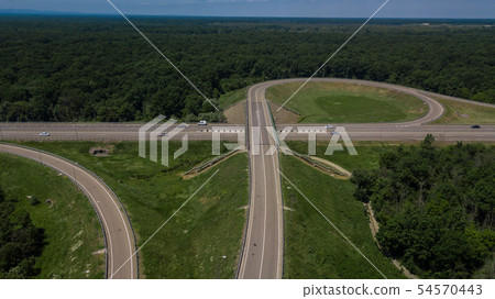 Aerial view of highway cloverleaf interchange seen from above. 54570443