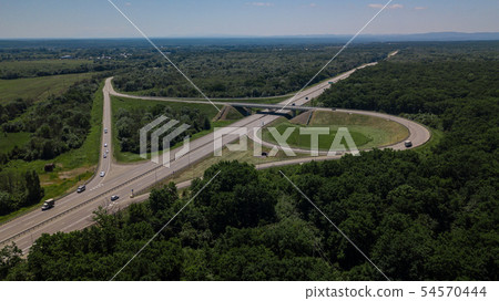 Aerial view of highway cloverleaf interchange seen from above. Aerial view of highway cloverleaf interchange seen from above. 54570444